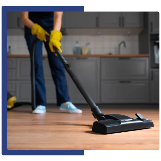 Professional cleaner vacuuming hardwood floor in San Jose home